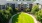 vast grass courtyard surrounded by trees and walkways