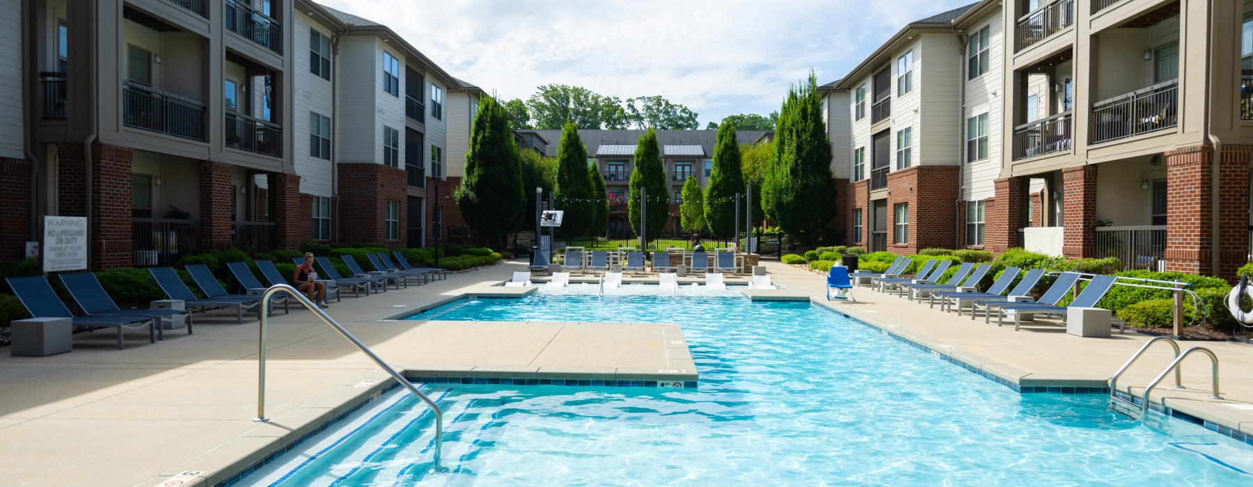 Pool with lounge chairs at Fountains Matthews luxury apartments in Matthews, NC.