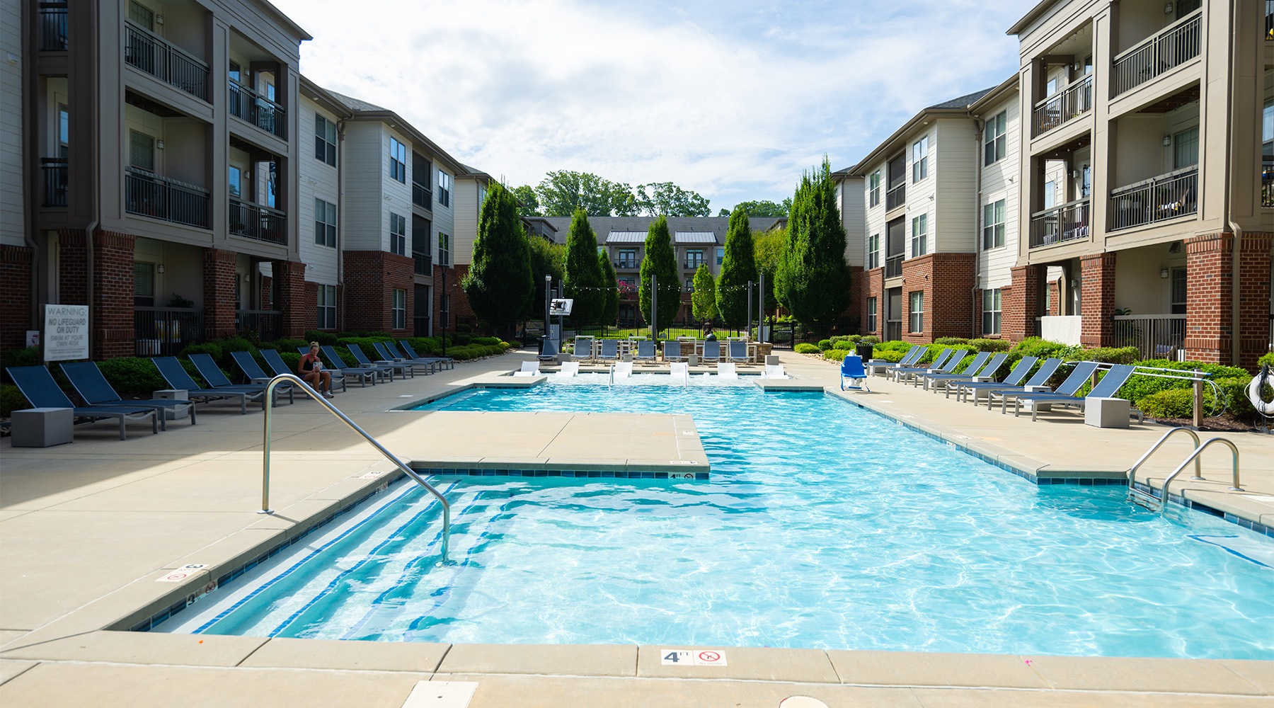 Aerial view of pool and courtyard at Fountains Matthews apartments in Matthews, NC.